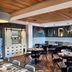 The Casso, Raleigh restaurant with patterned tile wall, wood ceiling, and dining tables