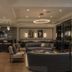 The Adelphi Hotel in Saratoga Springs lounge with bar, sofas, and modern chandelier lighting