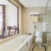 Shijiazhuang Shen Zhou 7 Star Hotel bathroom with bathtub, toilet, and glass shower