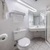 Beachcomber Beachfront Hotel, Panama City Beach bathroom with glass shower and vanity