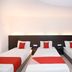Kenyalang Suite in Miri: triple room with three single beds and red bed runners