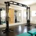 Hotel La Villette in Antananarivo fitness room with cable machine, mirrors, and teal bench
