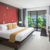 Centara Anda Dhevi Resort & Spa Krabi room with bed, balcony doors, and pool view in Ao Nang