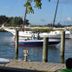 Tilghman Island Inn waterfront view with sailboats docked beside a wooden pier on Tilghman Island