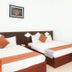 Volga Apartment Hotel in Mũi Né guest room with two beds and a wooden vanity mirror