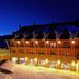 HG Alto Aragón in Formigal at dusk, with snow-covered grounds and warm-lit chalet-style balconies