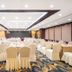 Redstar Culture Hotel Hangzhou banquet hall with round tables and cream-covered chairs