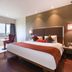 7 Apple Hotel Pimpri Pune room with bed, window seat and city view in Pimpri-Chinchwad