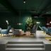 The Social Hub Amsterdam City lounge with modern chairs, tables and plants in Amsterdam