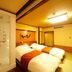 Tosagyoen Kochi guest room with twin beds and a glass shower booth