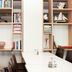 Good Morning+ Göteborg City meeting room with white tables, dark chairs, and built-in shelves in Gothenburg