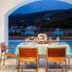 Kythea Resort in Agia Pelagia patio dining table with mountain and village view at dusk