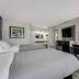Quality Inn Laurinburg guest room with two beds, desk, TV and chair in Laurinburg