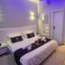 Spat Hotel Ashdod in Ashdod guest room with queen bed, wall mirror, and small desk nook
