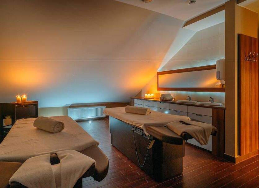 Mikolajki Resort by DeSilva spa treatment room with two massage tables in Mikołajki