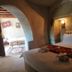 Seven Rock Cave Hotel in Göreme cave-style guest room with bed and arched doorway