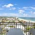 Royal Palm Resort in Palm Beach balcony with ocean view, city skyline, and table with chairs