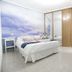CH La Bañezana Madrid guest room with double bed, cloud mural wall, desk and wardrobe