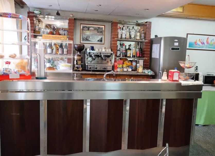 Hotel Piccolo in Lamezia Terme bar area with counter, espresso machine, and beverage display