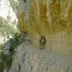 Albergue Rural Cal Picarol in Àger, scenic cliffside trail with two people under a rocky overhang