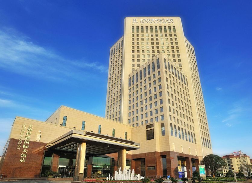 New Century Hotel Pudong Shanghai in Shanghai with a tall modern tower and entrance fountain