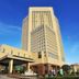 New Century Hotel Pudong Shanghai in Shanghai with a tall modern tower and entrance fountain