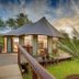 Karongwe Chisomo Safari Camp in Metz, safari tent suite with wooden deck and palm-framed sunset view