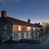 The Carpenters Arms in Bristol, stone inn beside a country road at sunset
