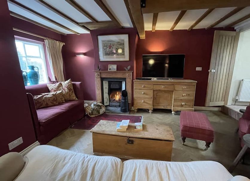 The Durham Ox in York living room with fireplace, TV, sofa and window seat