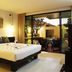 Palmyra Patong Resort Phuket (Sha Plus+) bedroom with king bed and sliding doors to a balcony