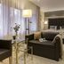 Hotel-Restaurant Barbarossahof in Kaiserslautern: modern guest room with sofa, armchairs and king bed