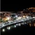 Panorama Junior Suites in Kavála overlooking a lit waterfront harbor and hillside city at night