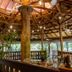 Le Plaza Hotel in Port Au Prince open-air lobby with wooden beams, ceiling fans and potted plants
