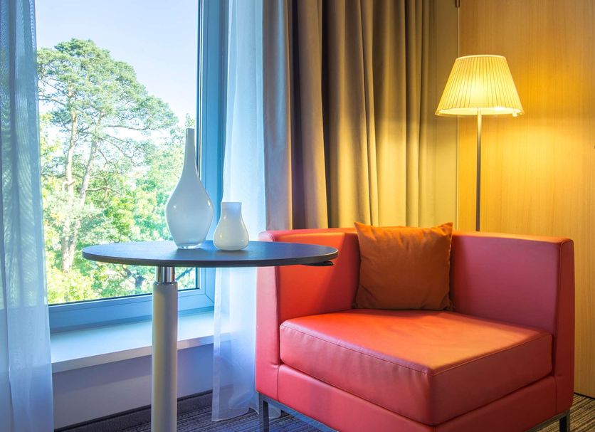 Park Inn by Radisson Frankfurt Airport corner chair by window with tree view in Frankfurt am Main