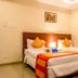 OYO 1594 Hotel Landmark, Visakhapatnam: twin beds with orange runners in a simple guest room