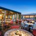 BLESS Hotel Madrid rooftop terrace with outdoor dining and city views at sunset