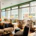 Lobby seating at Nyx Hotel Munich By Leonardo Hotels with large street-facing windows in Munich