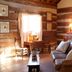 Hoffman Haus Fredericksburg rustic cabin-style guest room with leather sofa, desk, and wooden walls