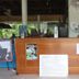 Thai Garden Inn Kanchanaburi front desk with wooden reception counter and open-air lobby