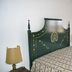 Monte das Palmeiras in Ferreira do Alentejo bedroom with decorative green headboard and patterned bedspread