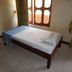 Leinmach House Nyali, Mombasa room with single bed, striped throw, and window curtains