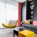 Hotel Bonvino Badacsony lounge with gray sofa, yellow chair, and colorful cushions in Badacsony