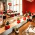 ibis Santiago Las Condes restaurant with red chairs, modern tables and pasta promotion display