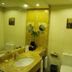 Gold River Side Hotel Jiaxing bathroom with marble vanity, sink, toilet, mirror and wall art