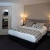 Sure Hotel by Best Western Limoges Sud room in Feytiat with double bed, sofa and mirrored wardrobe