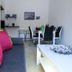 Flora Daisy Apartment in Borovets living room with sofa, dining table and kitchen area