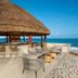 Dreams Aventuras Riviera Maya in Puerto Aventuras: beachfront palapa bar with ocean views and lounge seating