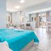 Stafylos Suites & Boutique hotel in Stafylos room with turquoise bedspread and bright sitting area