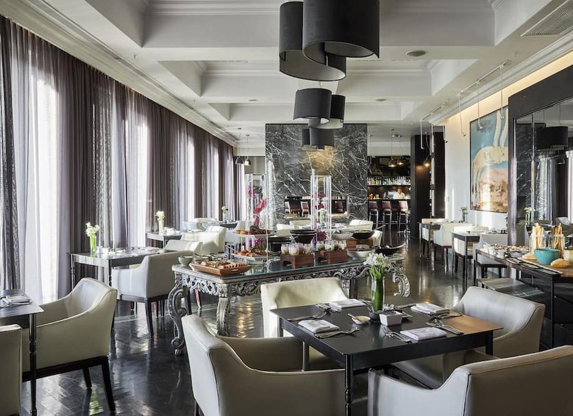 The Manor House At The Queen Victoria Hotel By Newmark Cape Town dining room with set tables and lounge seating