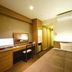 Business Hotel Cuore in Tsuruga guest room with desk, TV, bed, and air conditioner